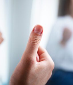 81625 Close-up of a hand giving a thumbs-up with a blurred background.