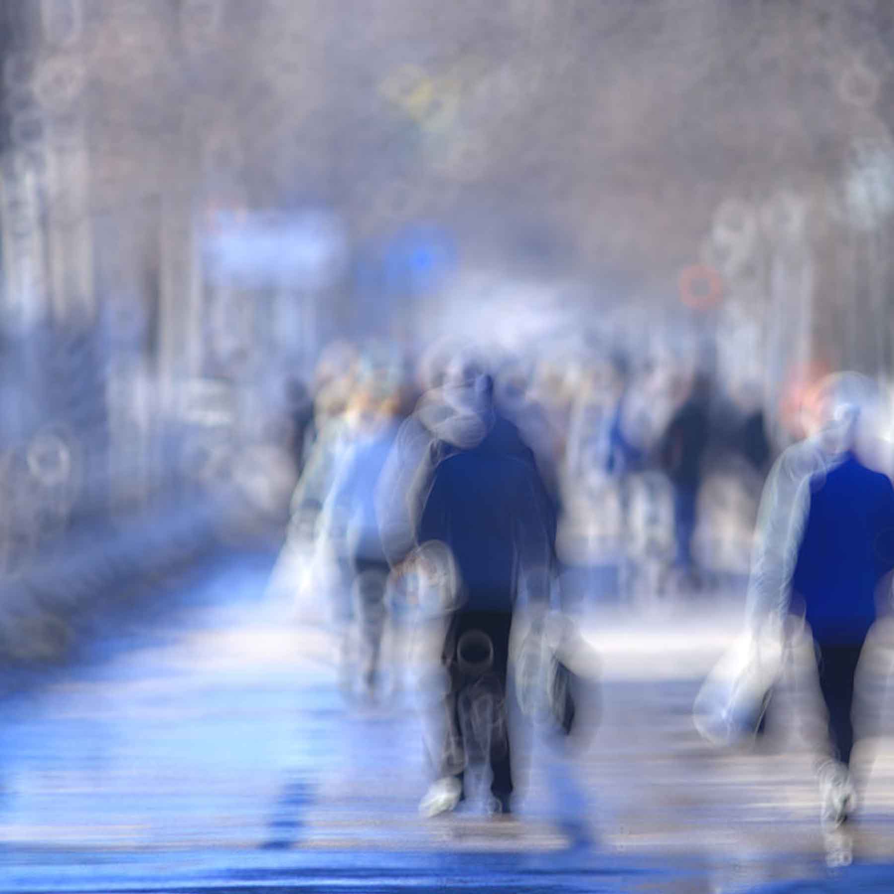 blurred-vision-1080x1080 Abstract blurred image of people walking on a street, symbolizing blurred vision or visual distortion.