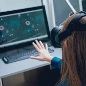 cvt Person using a virtual reality headset, reaching out toward a screen, illustrating VR therapy for vision-related ADHD.