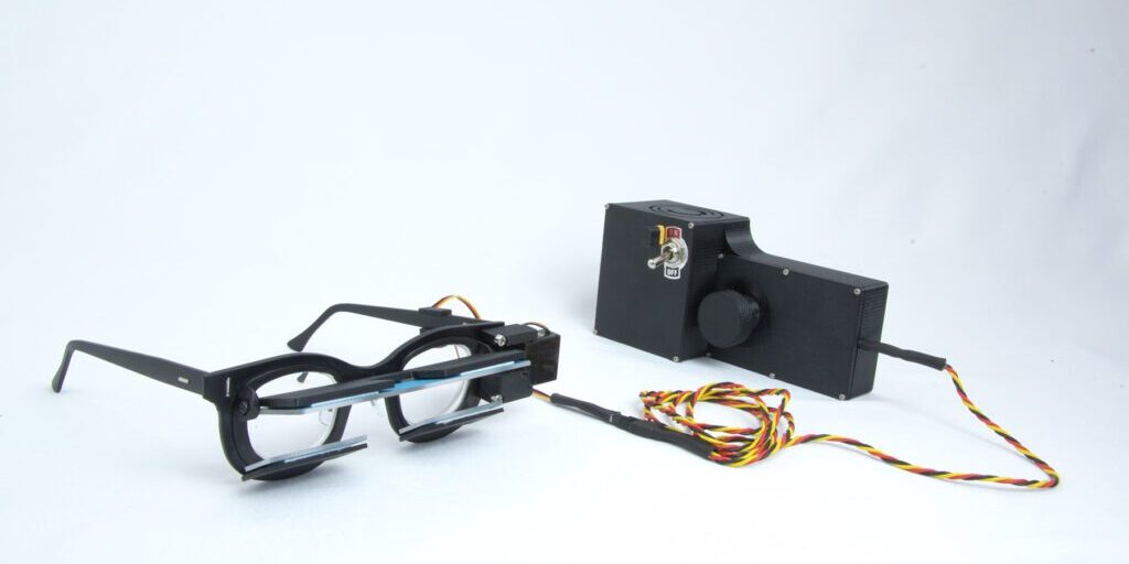 Engineering_Chadwick_Optical PrPeriscoping glasses setup connected to a control box with wires, developed by Chadwick Optical.totype glasses connected to a black control box with wires and an on/off switch, used for engineering or optical testing at Chadwick Optical.
