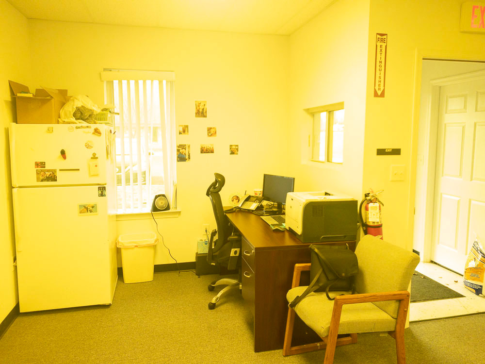 An office room under the 450x tint, which casts a vibrant yellow hue over the scene, brightening the walls and furniture while softening shadows and creating a warm, sunny effect.