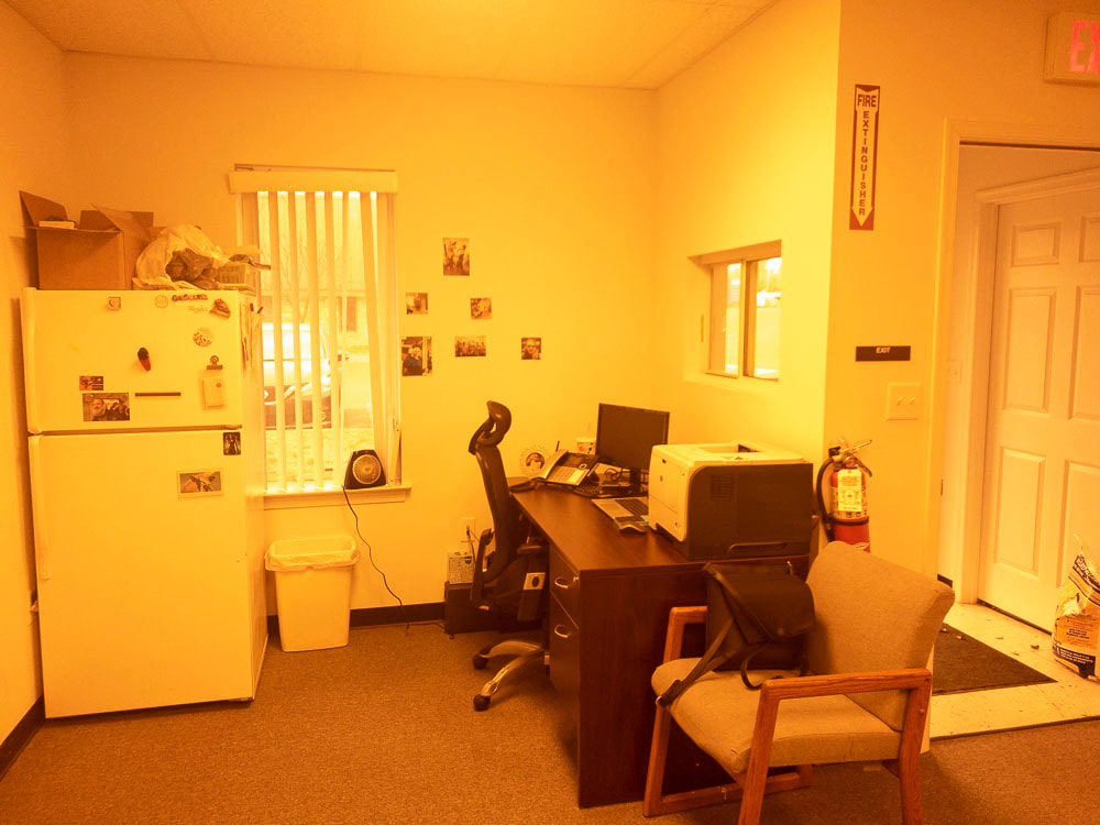 A view of an office room under the 527 tint, applying a rich orange filter that warms the room significantly, altering the overall color balance and visibility of details.
