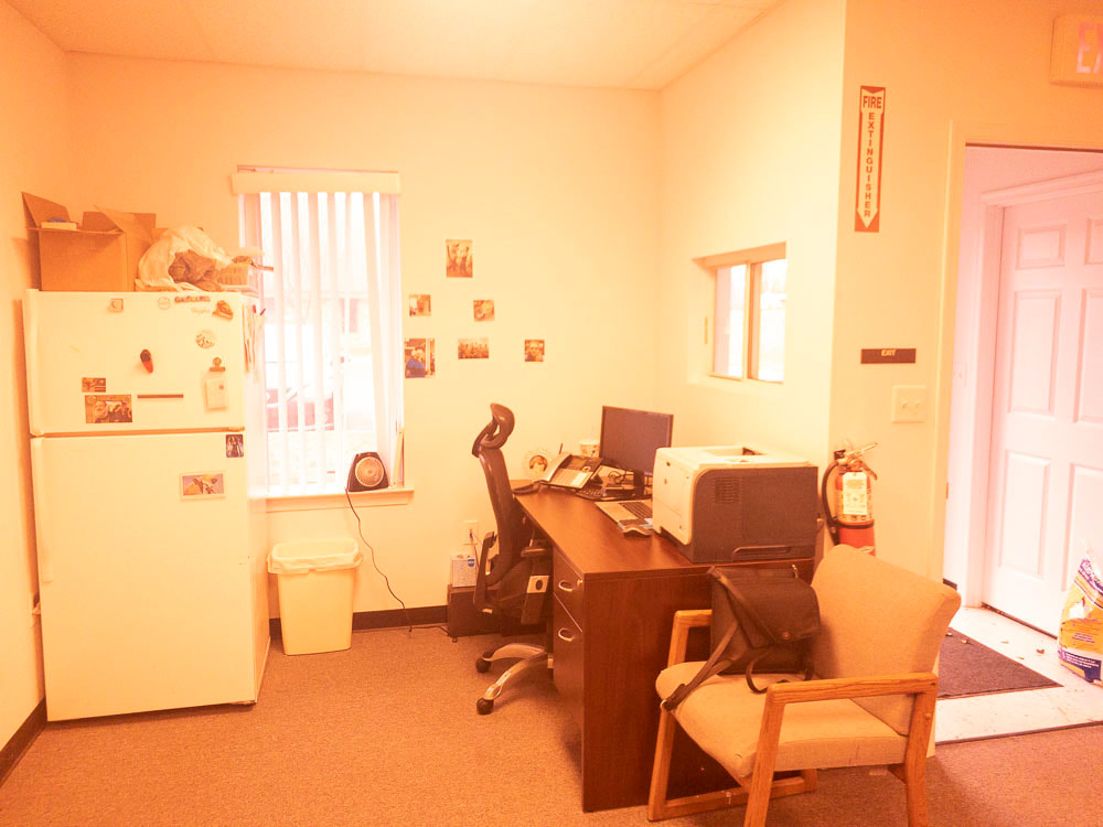 A view of an office room with the 527x tint, applying a warm orange-yellow overlay that significantly brightens the space, enhancing warmth and subtly affecting the clarity of furniture and details.