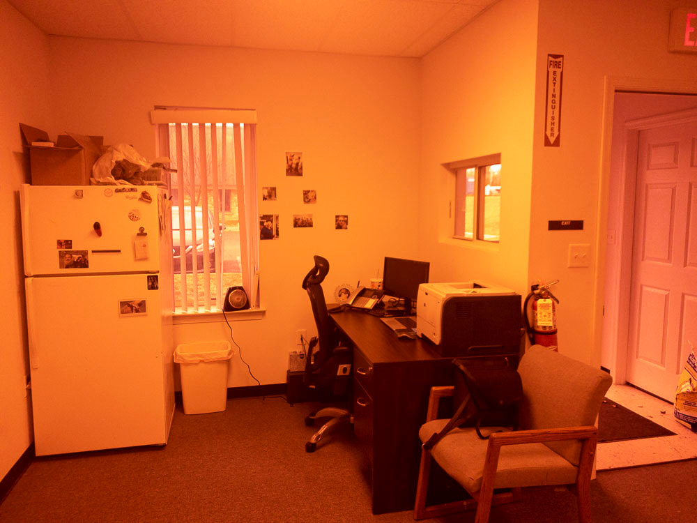 A view of an office room with the 550 tint, adding a light orange-yellow hue to the scene, which softly enhances the warmth without overpowering the visibility of furniture and other details.