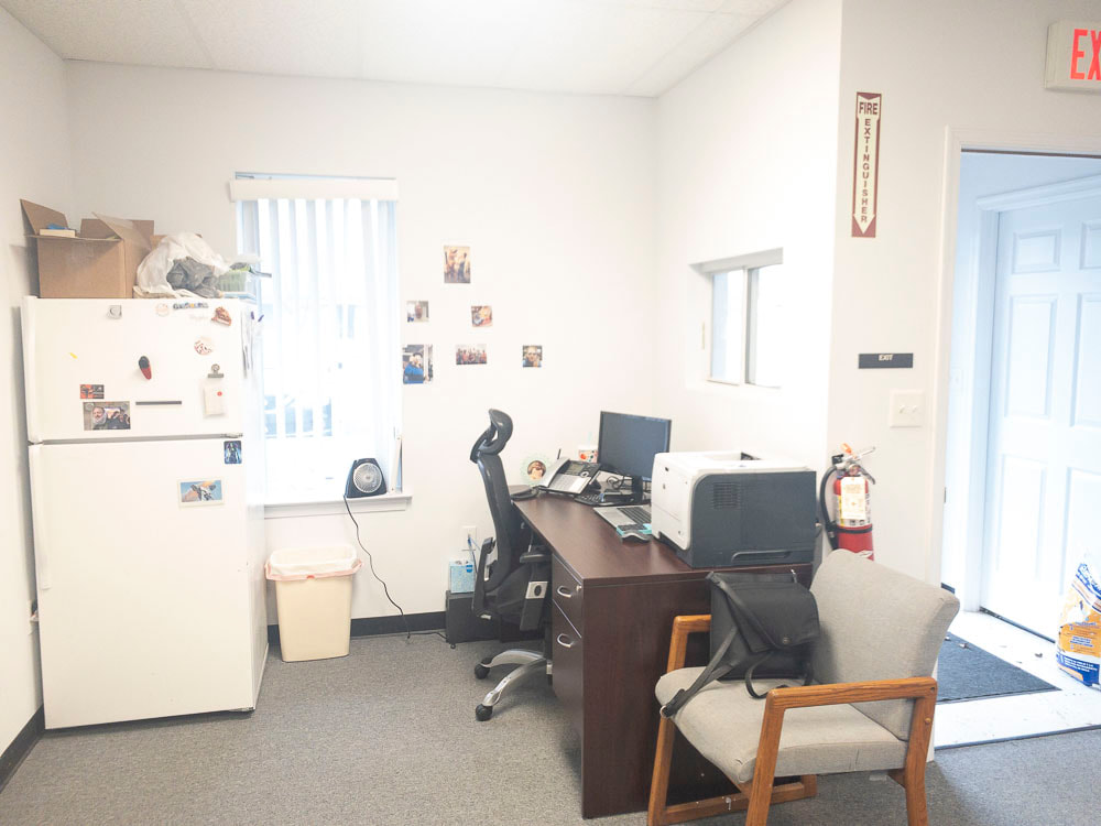A view of an office room under a blue-green tint, applied by the BlueGreen-20 filter, creating a soft teal hue that adds a cool and calming tone to the space, subtly enhancing the green and blue tones across the room.