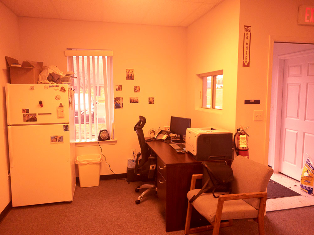 A view of an office room under a light rose tint, applied by the FL-41 filter, giving a faint pink glow that minimally affects the color of the room but adds a gentle warmth.