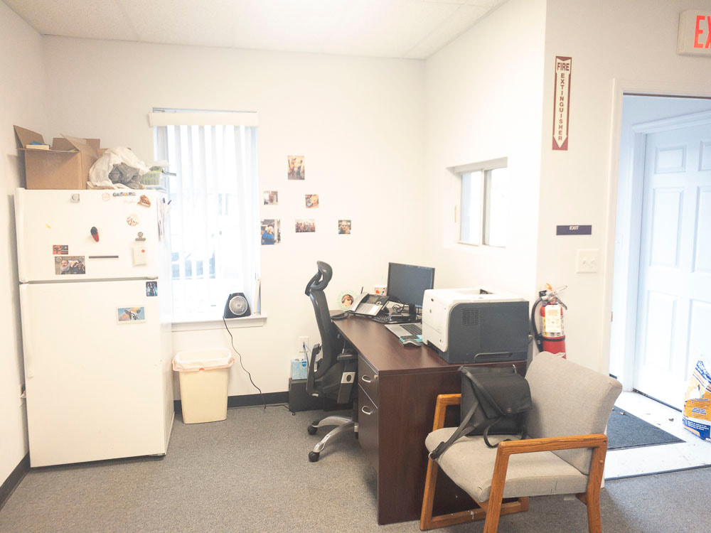 A view of an office room under a light rose tint, applied by the FL-41 filter, casting a soft pinkish hue that slightly warms the image, gently affecting color perception without obscuring room details.