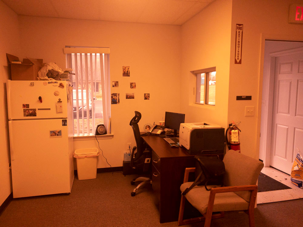 A view of an office room with a simulated glare reduction filter, cutting down on light reflections and enhancing contrast, making the room details more visible by minimizing harsh lighting effects.