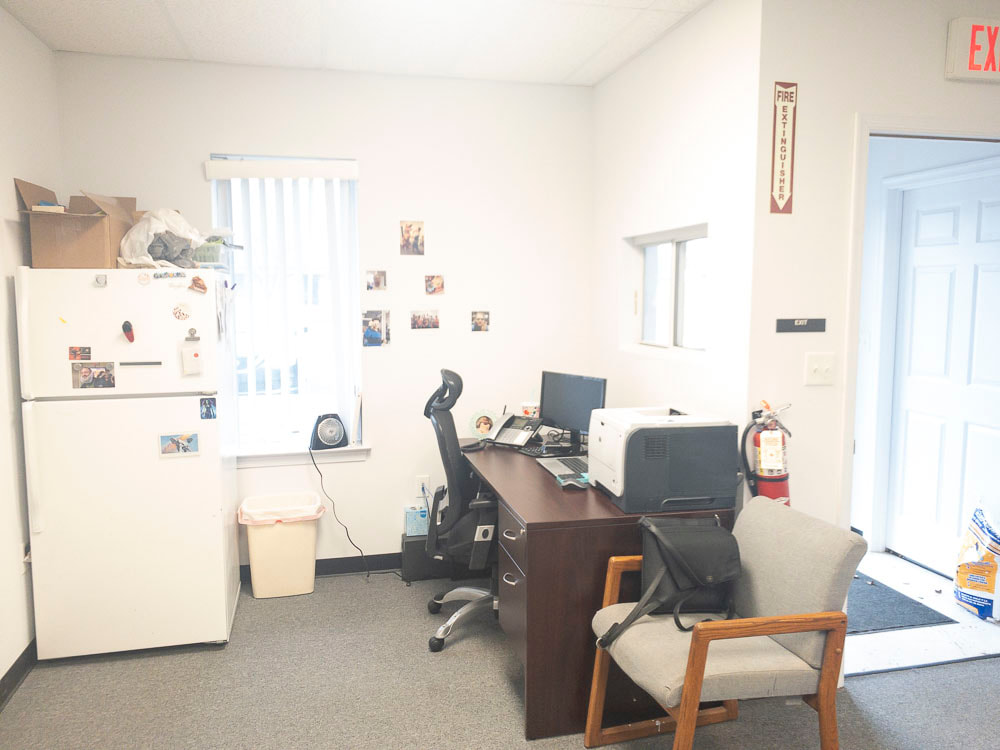 A view of an office room under a greenish-blue tint, creating a distinct, calm overlay that enhances green and blue tones, altering the ambiance of the room significantly and affecting visibility of natural colors.
