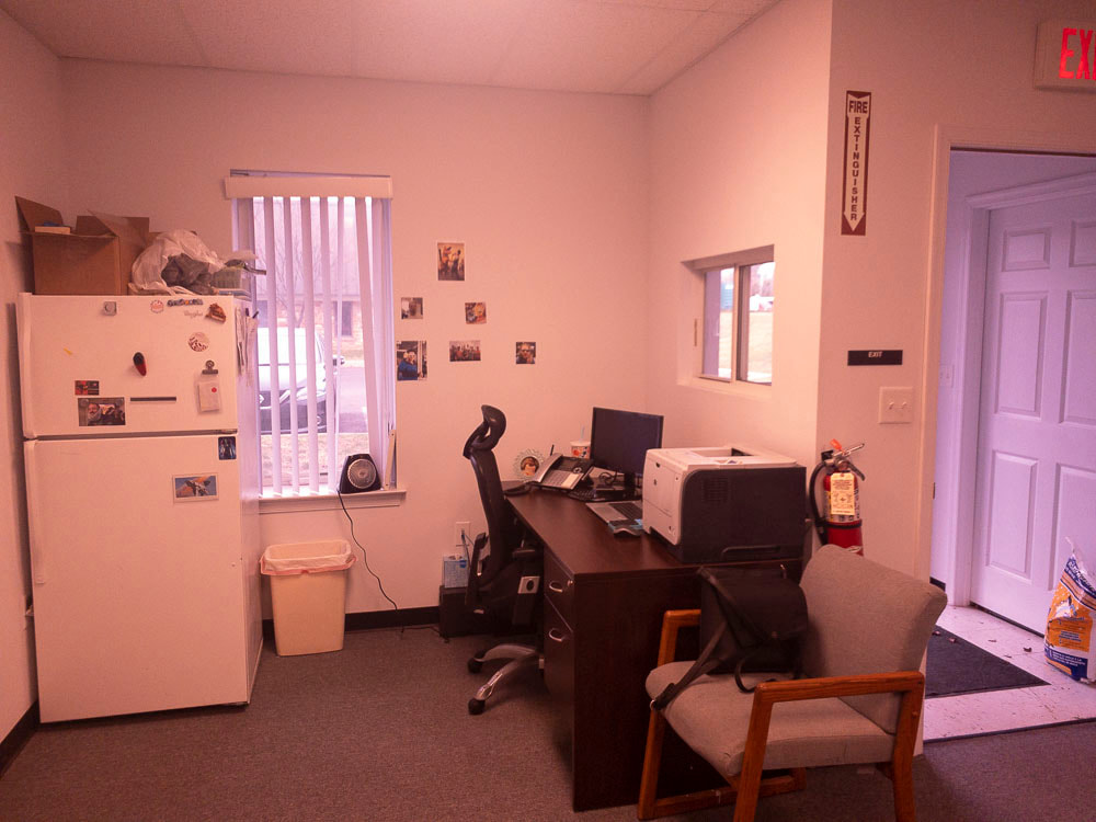 A view of an office room under a dark plum tint, applied by the Noir 81 filter, creating a rich, deep purple overlay that reduces brightness and changes the appearance of colors, affecting the visibility of fine details.