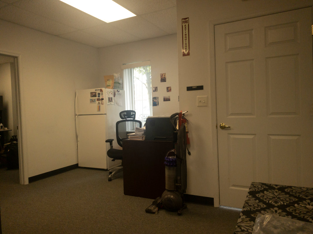 A view of an office room through the Noir 42 filter, displaying a very light amber tint that subtly warms the scene while preserving much of the room’s natural lighting and detail.
