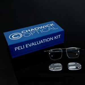 peli evaluation kit Chadwick Optical Peli Evaluation Kit box with glasses and specialized prism lenses, displayed on a black surface.